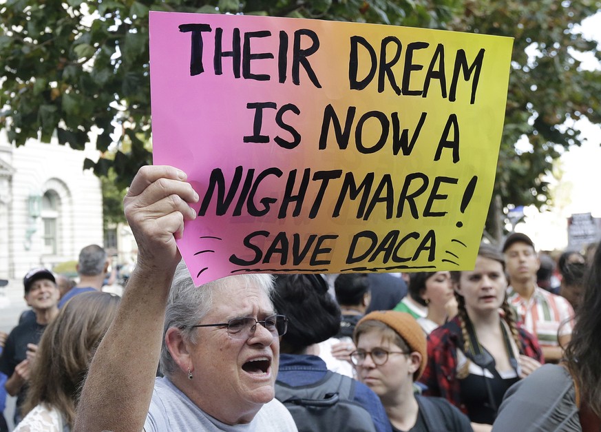 FILE - In this Sept. 15, 2017, file photo, Judy Weatherly, a supporter of the Deferred Action for Childhood Arrivals (DACA) holds up a sign during a protest outside of the Federal Building in San Fran ...