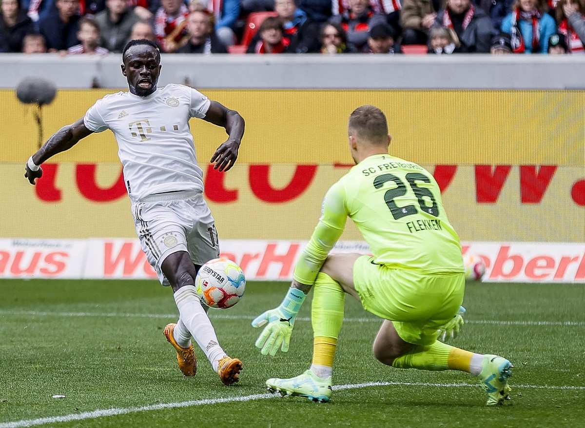 epa10564738 Munich's Sadio Mane (L) in action against Freiburg's goalkeeper Mark Flekken (L) during the German Bundesliga soccer match between SC Freiburg and FC Bayern Munich in Freiburg, G ...