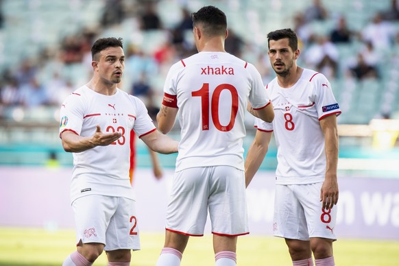 Switzerland&#039;s midfielder Xherdan Shaqiri, left, talks to Switzerland&#039;s midfielder Granit Xhaka and Switzerland&#039;s midfielder Remo Freuler during the Euro 2020 soccer tournament group A m ...