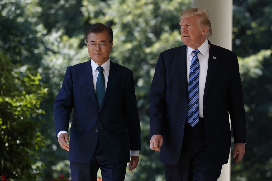 President Donald Trump walks with South Korean President Moon Jae-in to make statements in the Rose Garden of the White House in Washington, Friday, June 30, 2017. (AP Photo/Evan Vucci)