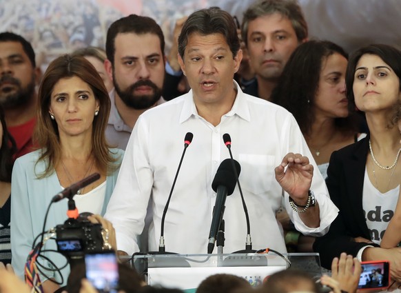 Flanked by his wife Ana Estela, left, and running mate Manuela d&#039;Avila, Workers&#039; Party presidential candidate Fernando Haddad delivers his concession speech, in Sao Paulo, Brazil, Sunday, Oc ...