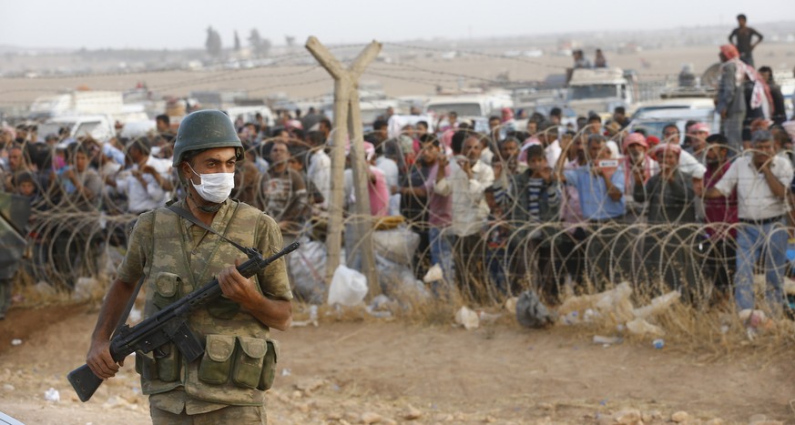 Flüchtlinge an der türkisch-syrischen Grenze.