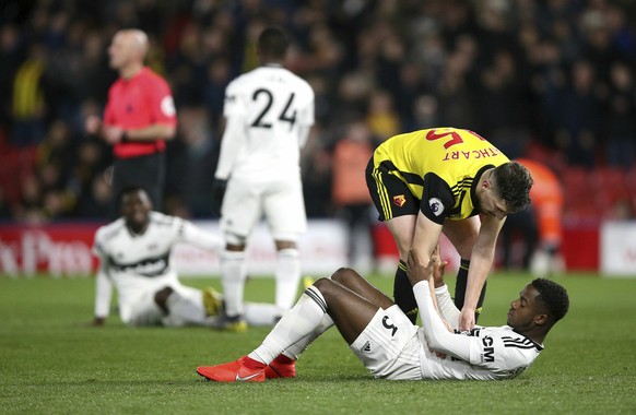 Fulham&#039;s Ryan Sessegnon is consoled by Watford&#039;s Craig Cathcart after the final whistle of the English Premier League soccer match against Watford at Vicarage Road, Watford, England, Tuesday ...