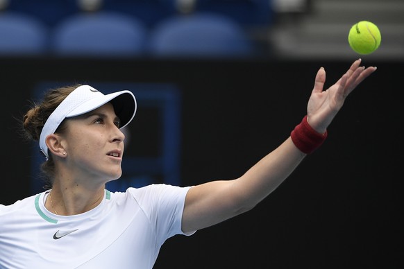 Belinda Bencic of Switzerland serves to Kristina Mladenovic of France during their first round match at the Australian Open tennis championships in Melbourne, Australia, Monday, Jan. 17, 2022. (AP Pho ...