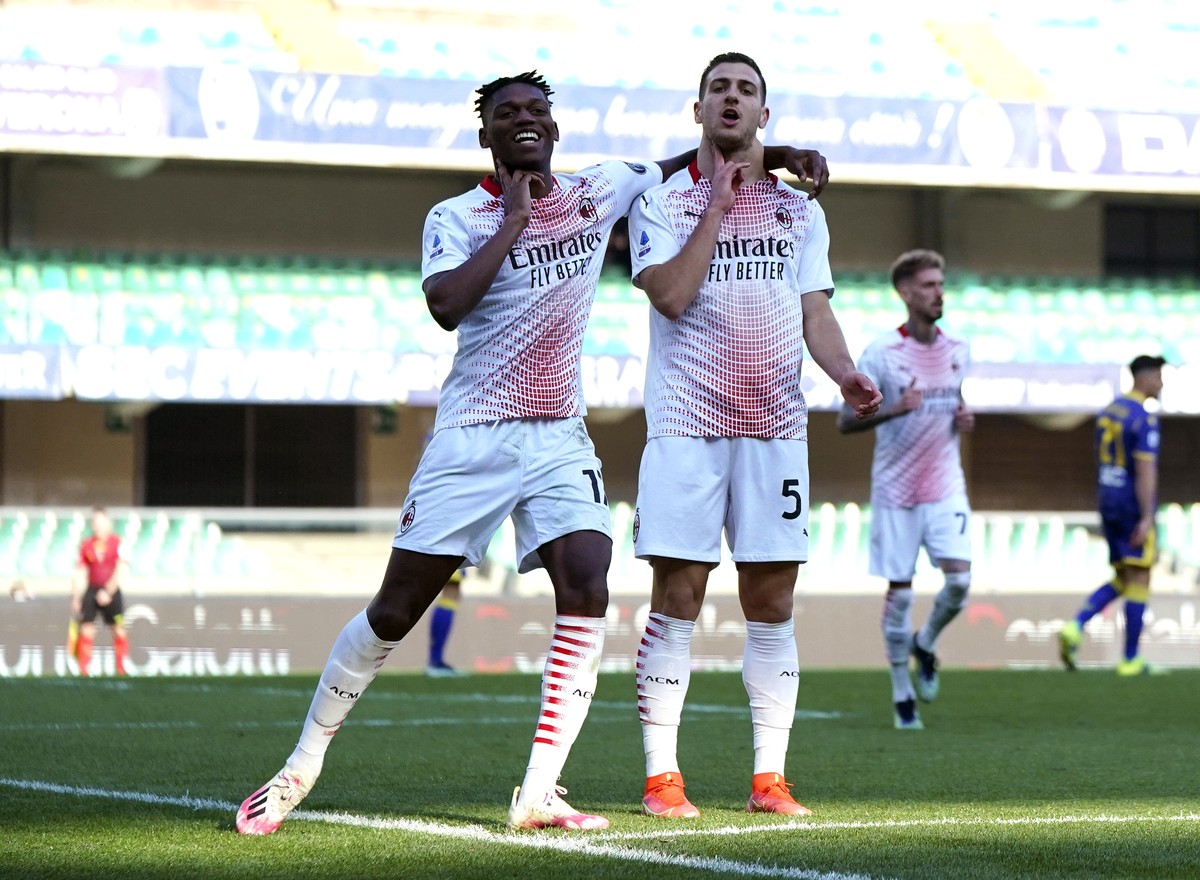 AC Milan's Jose Diogo Dalot Teixeira, right, celebrates with his teammate Rafael Leao after scoring his side's second goal during a Serie A soccer match between Hellas Verona and AC Milan, a ...