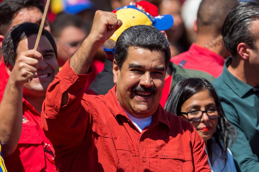 epa06569132 Venezuelan President Nicolas Maduro gestures to supporters during an event where he has presented his re-election candidacy before the National Electoral Council (CNE), in Caracas, Venezue ...