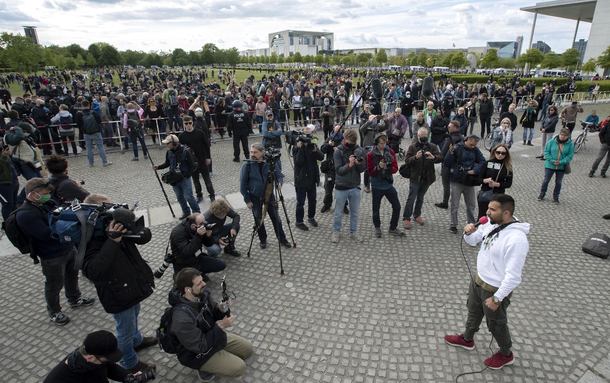 The vegan chef Attila Hildmann, front right, delivers a speech during a demonstration against restrictions and measures to prevent the spread of the new coronavirus in Berlin, Germany, Saturday, May 1 ...