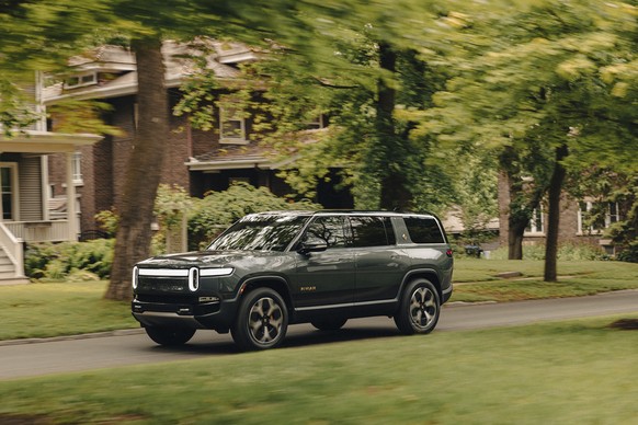 This photo provided by Rivian shows the 2024 R1S. The R1S is ready for adventure thanks to a potential range of 400 miles and up to 835 horsepower. (Nolis Anderson/Courtesy of Rivian Automotive via AP ...