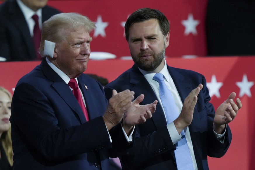 Republican presidential candidate former President Donald Trump and Republican vice presidential candidate Sen. JD Vance, R-Ohio, applaud during the Republican National Convention Monday, July 15, 202 ...