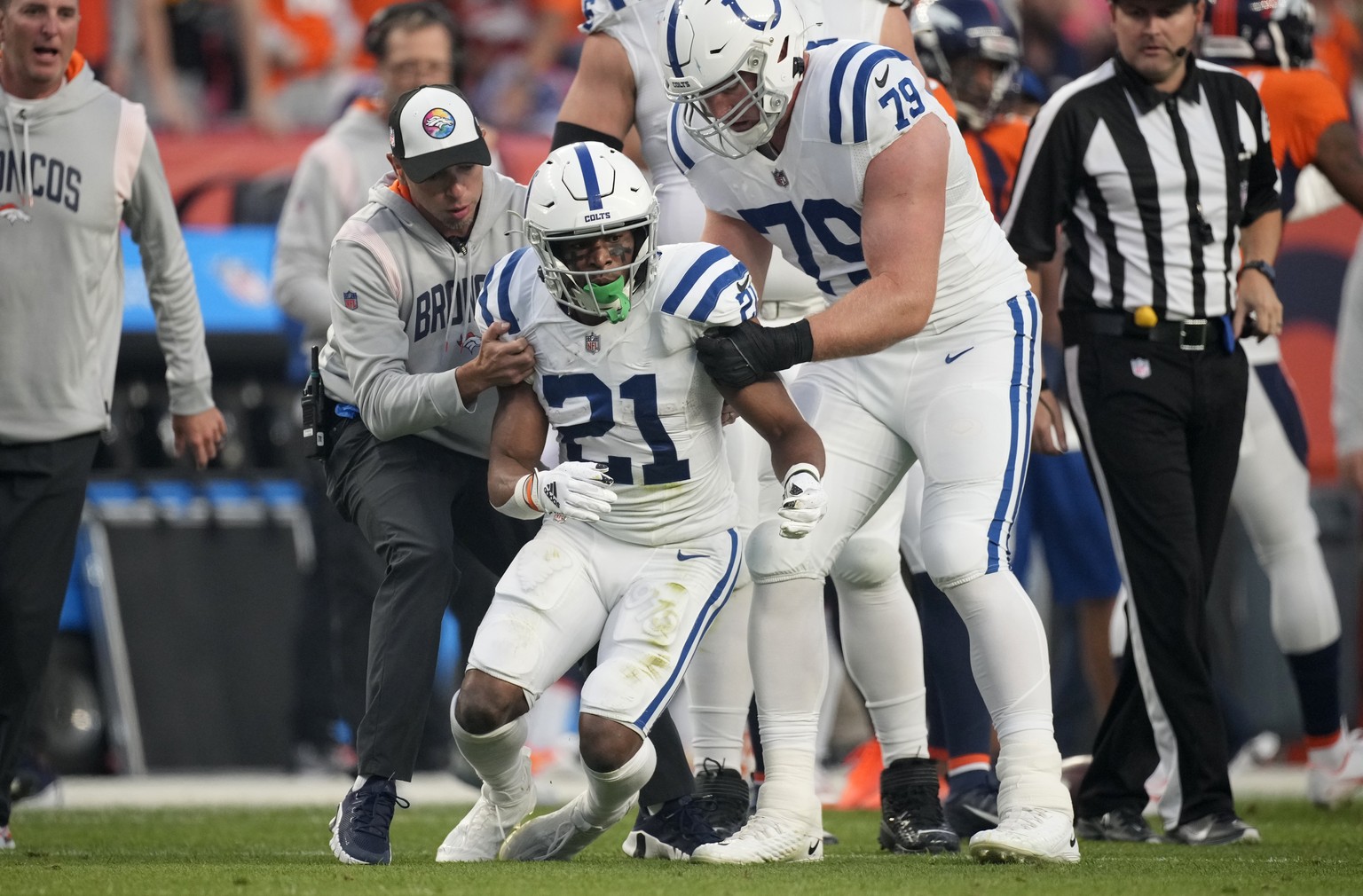 Indianapolis Colts running back Nyheim Hines (21) stumbles as he tries to get up after being injured against the Denver Broncos during the first half of an NFL football game, Thursday, Oct. 6, 2022, i ...