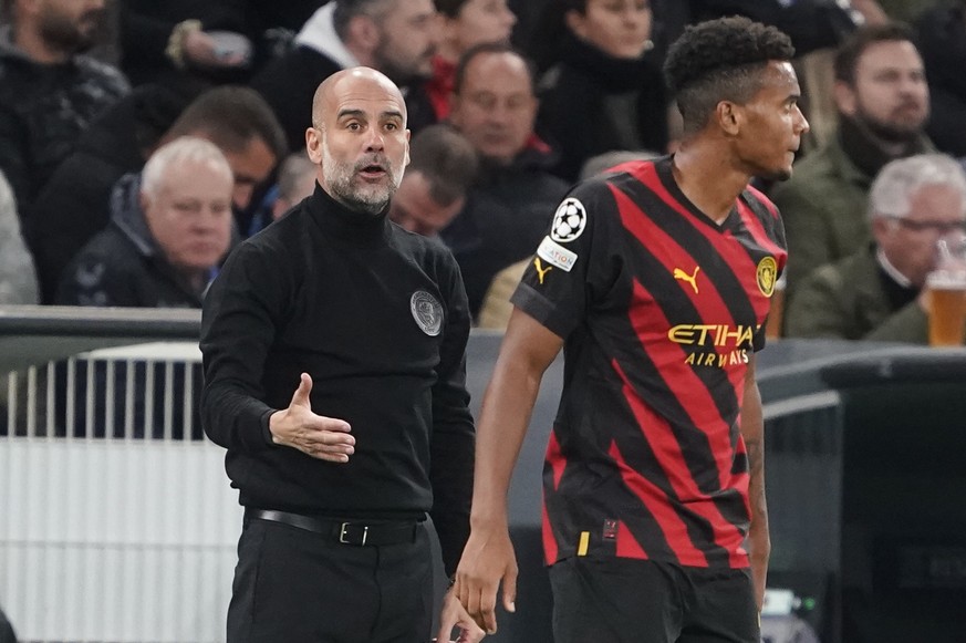 epa10236718 Manchester City&#039;s head coach Pep Guardiola and player Manuel Akanji during the group G Champions League soccer match between FC Copenhagen and Manchester City FC in Copenhagen, Denmar ...