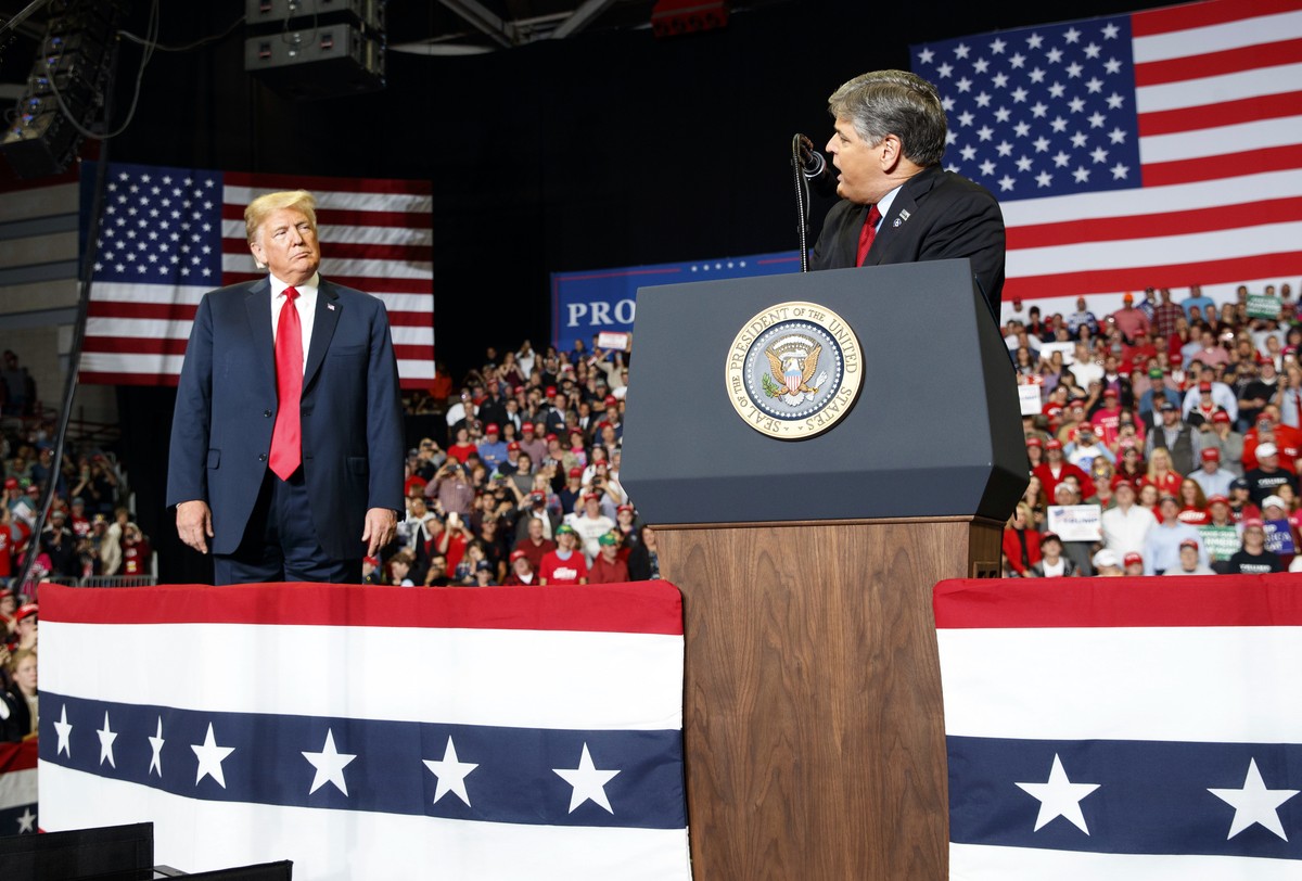 President Donald Trump listens Fox News' Sean Hannity speak during a rally at Show Me Center, Monday, Nov. 5, 2018, in Cape Girardeau, Mo.. (AP Photo/Carolyn Kaster)