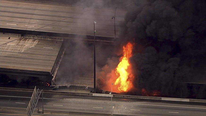 In this aerial image made from a video provided by WSB-TV, a large fire that caused an overpass on Interstate 85 to collapse burns in Atlanta, Thursday, March 30, 2017. Witnesses say troopers were tel ...