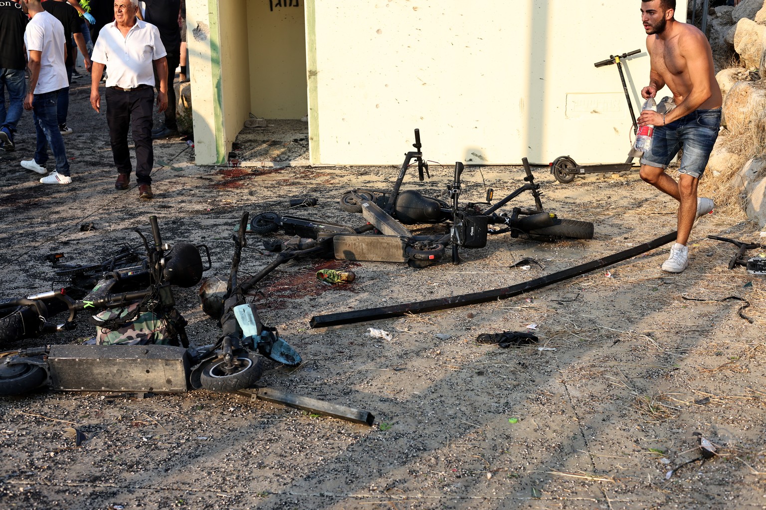 epa11500477 Damaged electric scooters at the site where a projectile hit a playground in Druze, Majdal Shams, in the annexed Golan Heights, 27 July 2024. According to the Israel Defence Forces (IDF),  ...