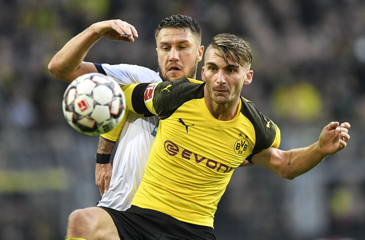 Dortmund's Maximilian Philipp, in front, and Hoffenheim's Ermin Bicakcic challenge for the ball during the German Bundesliga soccer match between Borussia Dortmund and TSG 1899 Hoffenheim in ...