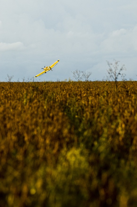 Airplane sprays pesticide over soy plantation at Fartura Farm, in Mato Grosso state, Brazil. Brazil is the second largest soy producer worldwide. (Photo by Paulo Fridman/Corbis via Getty Images)