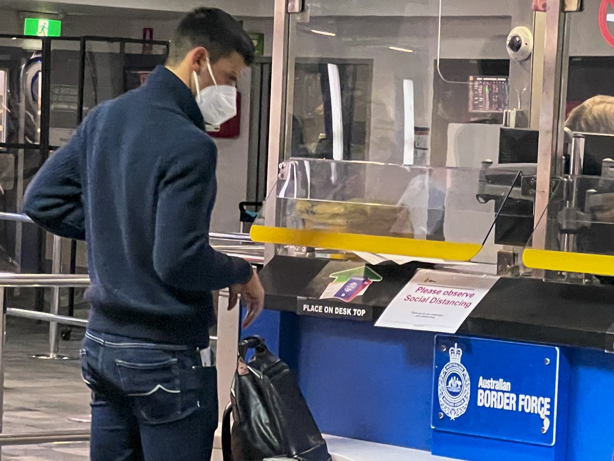 Serbia's Novak Djokovic, the Australian Open defending champion, waits at an Australian Border Force desk on his arrival at Melbourne Airport, Wednesday, Jan. 5, 2022. Locked in a dispute over hi ...