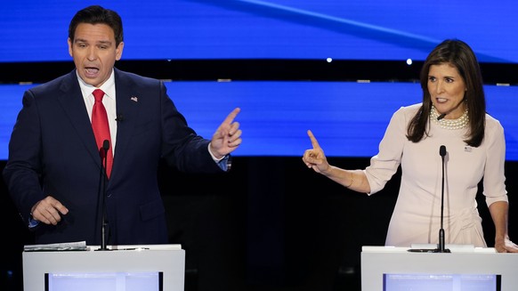 Former UN Ambassador Nikki Haley, right, and Florida Gov. Ron DeSantis, left, both speaking at the at the CNN Republican presidential debate at Drake University in Des Moines, Iowa, Wednesday, Jan. 10 ...