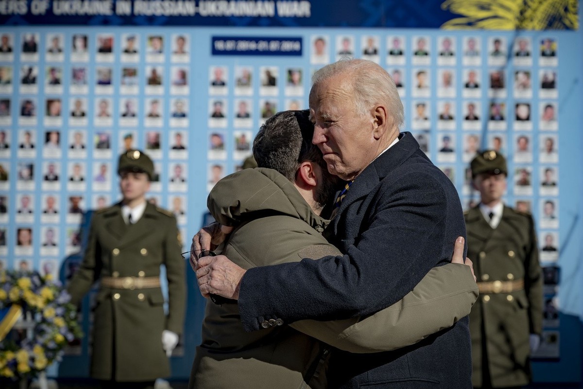 President Joe Biden, right, and Ukrainian President Volodymyr Zelenskyy hug as they say goodbye at the Memorial Wall of Fallen Defenders of Ukraine in Russian-Ukrainian War with photos of killed soldi ...