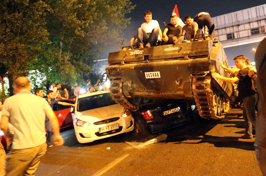 epa06067054 (FILE) - People on a tank run over cars on a road in Istanbul, Turkey, 16 July 2016 (reissued 05 July 2017). 15 July 2017 marks the first anniversary of a failed coup attempt in Turkey. Tu ...