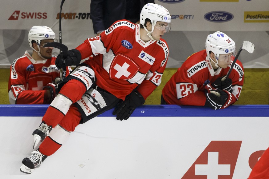 Switzerland&#039;s forward Nico Hischier, left, jumps over the board past teammate forward Philipp Kurashev, right, during a friendly international ice hockey game between Switzerland and France, at t ...