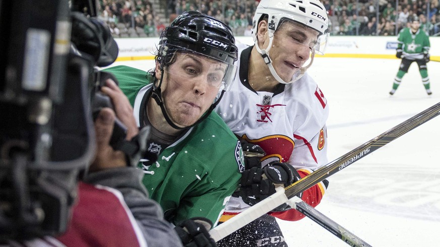 Dec 6, 2016; Dallas, TX, USA; Calgary Flames right wing Garnet Hathaway (64) checks Dallas Stars right wing Brett Ritchie (25) into a video cameraman during the third period at the American Airlines C ...