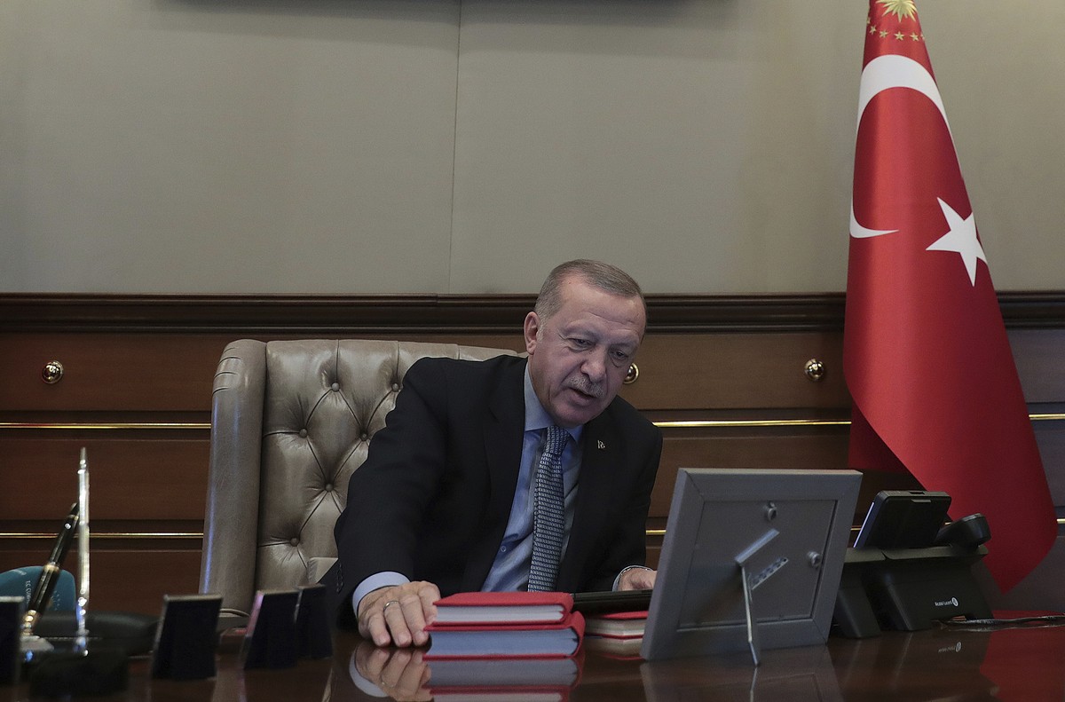 Turkey's President Recep Tayyip Erdogan speaks on the phone with Defense Minister Hulusi Akar before reportedly giving orders for the start of the military operation into Syria, in Ankara, Turkey ...
