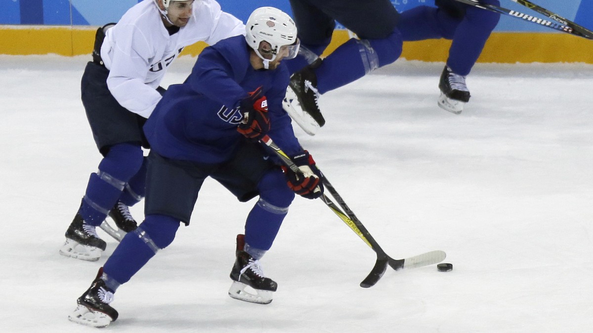 United State's Ryan Gunderson battles controls the puck against Mark Arcobello, left, during practice ahead of the 2018 Winter Olympics in Gangneung, South Korea, Friday, Feb. 9, 2018. (AP Photo/ ...