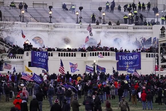 FILE - In this Jan. 6, 2021, file photo, violent protesters, loyal to then-President Donald Trump, storm the Capitol, Wednesday, Jan. 6, 2021, in Washington. Two Seattle police officers who were in Wa ...