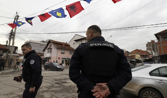 Kosovo police officers guard a street in northern, Serb-dominated part of ethnically divided town of Mitrovica, Kosovo, Friday, Dec. 9, 2022. On Thursday, police increased their presence in the four e ...