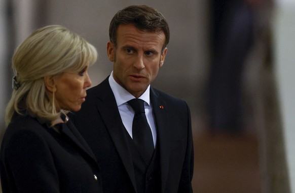 France&#039;s President Emmanuel Macron and first lady Brigitte Macron pay their respects to the coffin of Britain&#039;s Queen Elizabeth, following her death, during her lying-in-state at Westminster ...