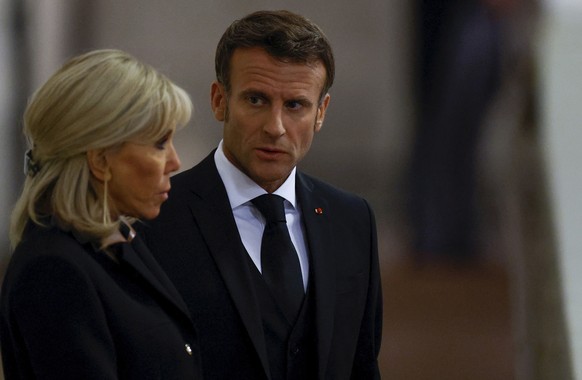 French President Emmanuel Macron and First Lady Brigitte Macron pay their respects to the coffin of Britain's Queen Elizabeth, after her death, while in state at Westminster Hall, in…