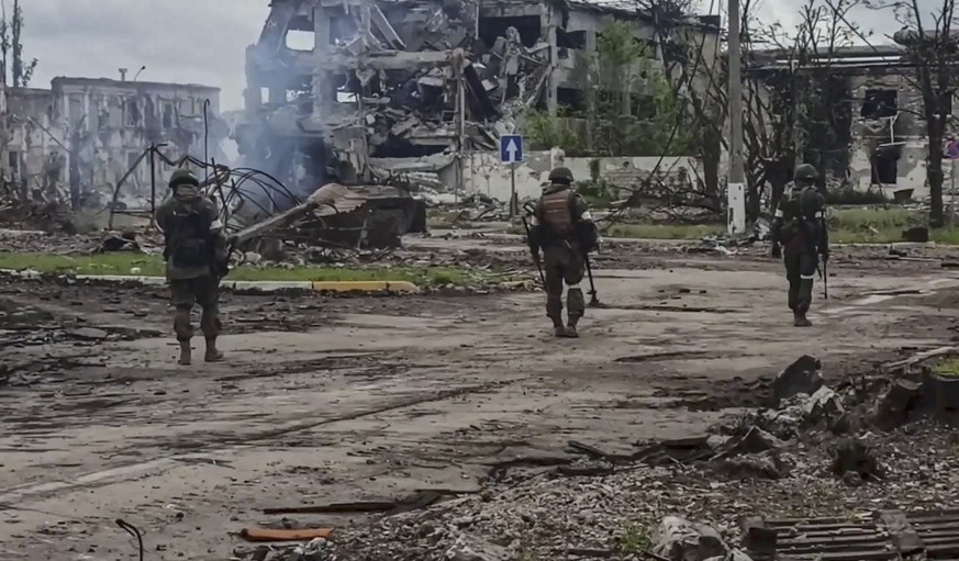 epa09969706 A still image taken from a handout video made available by the Russian Defense Ministry press service on 23 May 2022 shows Russian servicemen demining the territory of the Azovstal steel p ...