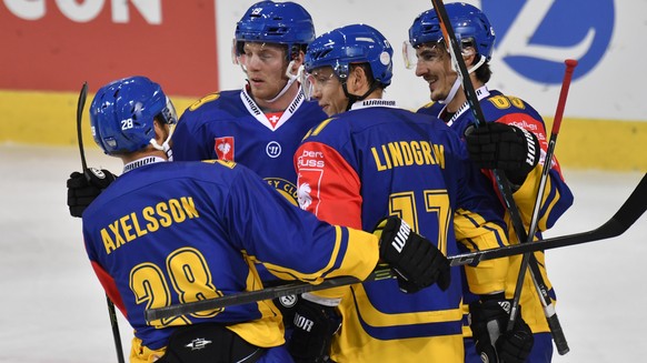 Davos&#039;s Dick Axelsson (SWE), Marc Aeschlimann, Perttu Lindgren (FIN) and goal scorer Dino Wieserare, from left to right, celebrate after their first leading 1:0 score, during the Champions Hockey ...