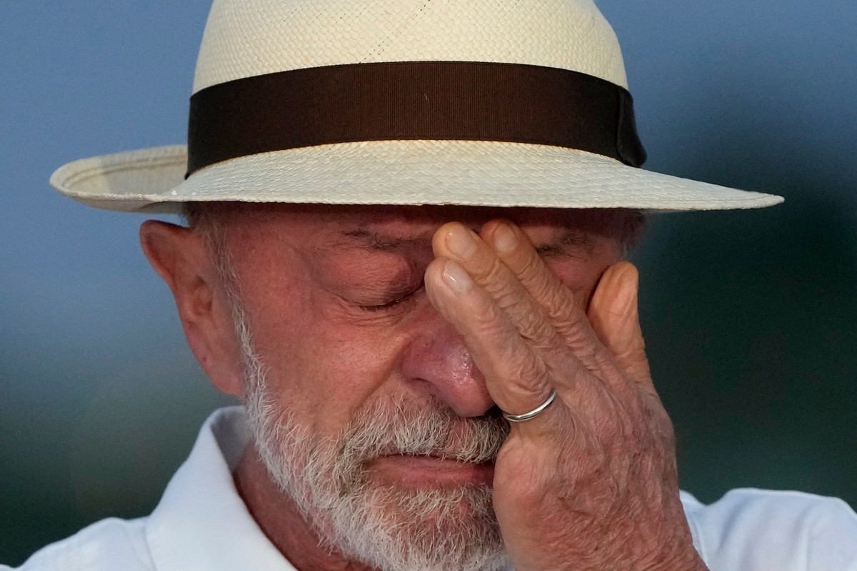 Reelected Brazilian President Luiz Inacio Lula da Silva wipes away tears as he speaks to supporters during a celebration of his 81st birthday outside the official presidential residence at Alvorada Pa ...
