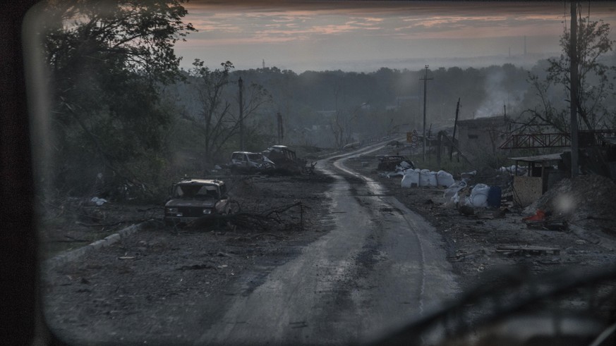 The gutted remains of cars lie along a road during heavy fighting at the front line in Severodonetsk, Luhansk region, Ukraine, Wednesday, June 8, 2022. (AP Photo/Oleksandr Ratushniak)