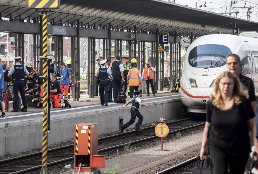 Firefighters and Police officers stay next to an ICE highspeed train at the main station in Frankfurt, Germany, Monday, July 29, 2019. German police say a child has died after apparently being pushed  ...