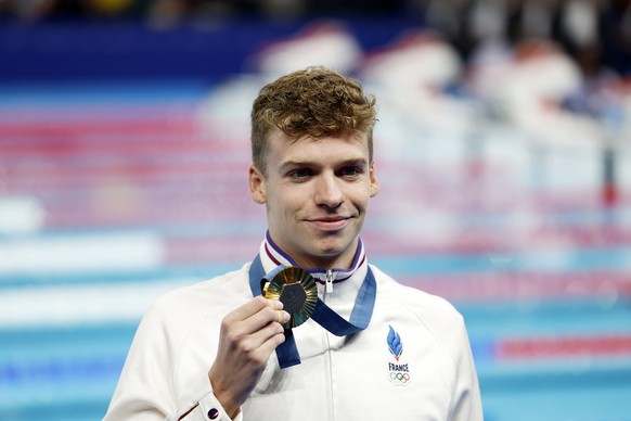 epa11520640 Gold medalist Leon Marchand of France poses for photos after the podium for the Men 200m Individual Medley final of the Swimming competitions in the Paris 2024 Olympic Games, at the Paris  ...