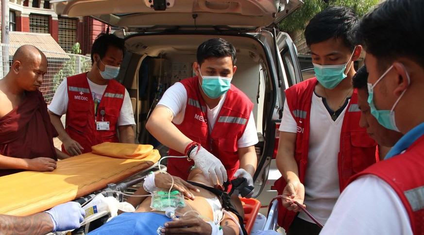 An injured anti-coup protester is brought for medical treatment to a hospital in Latha township, Yangon, Myanmar, Saturday, March 27, 2021. As Myanmar