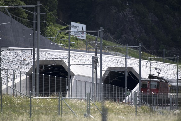 A train passes in front of the northern portal of the Gotthard Base Tunnel on the eve of its inauguration, in Erstfeld, Canton of Uri, Switzerland, Tuesday, May 31, 2016. The Gotthard Base Tunnel, wor ...