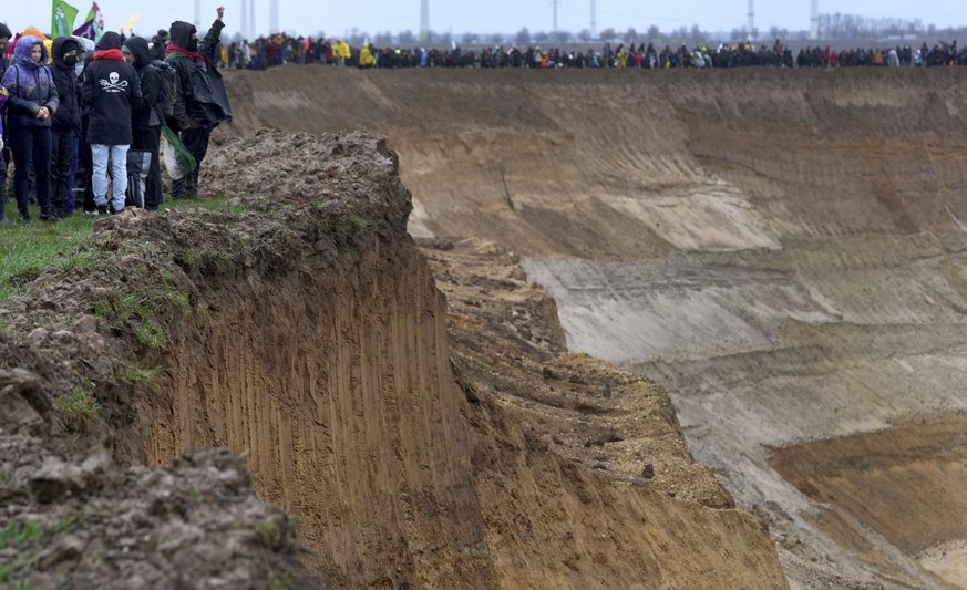 People attend a protest rally at the Garzweiler opencast mining near the village Luetzerath in Erkelenz, Germany, Saturday, Jan. 14, 2023. Swedish climate campaigner Greta Thunberg takes part in that  ...