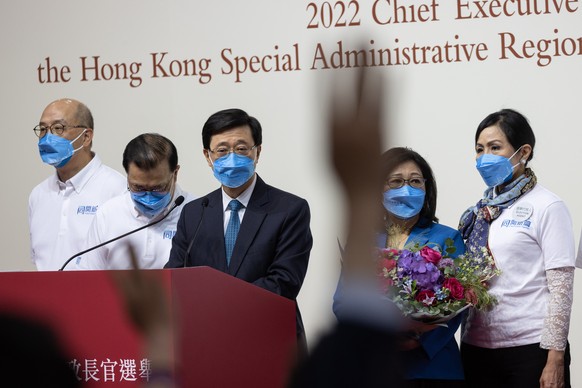 epaselect epa09933144 Hong Kong Chief Executive-elect John Lee Ka-chiu (C) attends a press conference after being elected, at the Exhibition and Convention Centre in Hong Kong, China, 08 May 2022. Lee ...