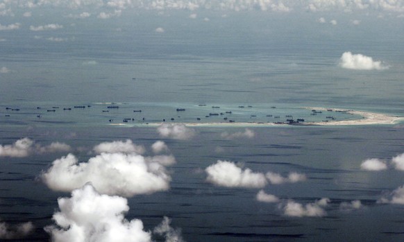 FILE - This May 11, 2015, file photo, shows land reclamation of Mischief Reef in the Spratly Islands by China in the South China Sea. China is protesting a U.S. Navy patrol that brought a guided missi ...