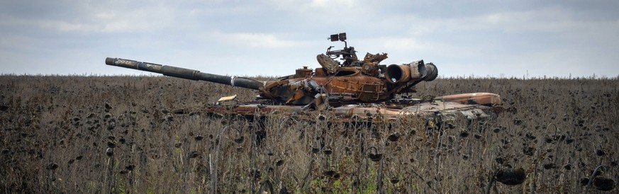 A Russian tank damaged in recent fighting is seen in the field of unharvested sunflowers near the recently retaken village of Kamianka, Kharkiv region, Ukraine, Sunday, Oct. 30, 2022. (AP Photo/Efrem  ...