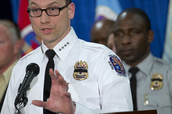 A black band covers the badge of Prince Georges County police chief Henry P. Stawinski as he speaks about the shooting of police officer Jacai Colson, during a news conference at at Prince George&#03 ...