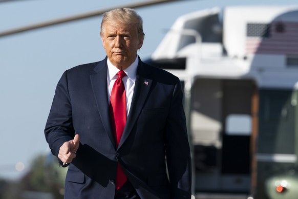 President Donald Trump points as he boards Air Force One, Wednesday, Oct. 14, 2020, at Andrews Air Force Base, Md. Trump is en route to Iowa. (AP Photo/Alex Brandon)
Donald Trump
