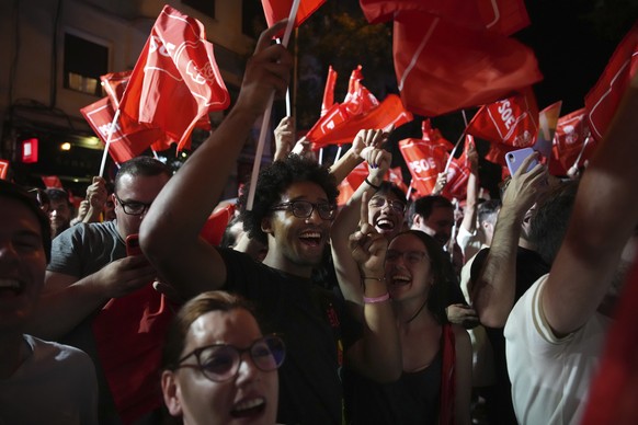 Socialist workers party supporters cheer as they wait for Prime Minister and Socialist Party leader Pedro Sanchez outside the party headquarters in Madrid, Spain, Sunday, July 23, 2023. Spa ...