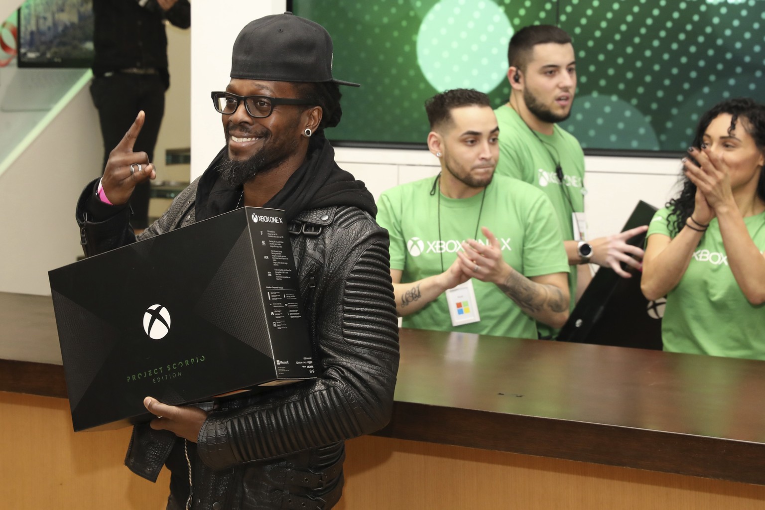 IMAGE DISTRIBUTED FOR MICROSOFT - A fan celebrates purchasing an Xbox One X Project Scorpio Edition at the flagship Microsoft Store on Fifth Avenue on Monday, Nov. 6, 2017, in New York City. (Photo by ...