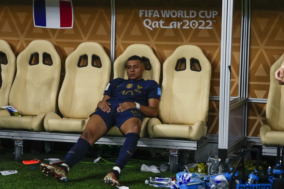 France's Kylian Mbappe sits on the bench at the end of the World Cup final soccer match between Argentina and France at the Lusail Stadium in Lusail, Qatar, Sunday, Dec.18, 2022. (AP Photo/Manu F ...