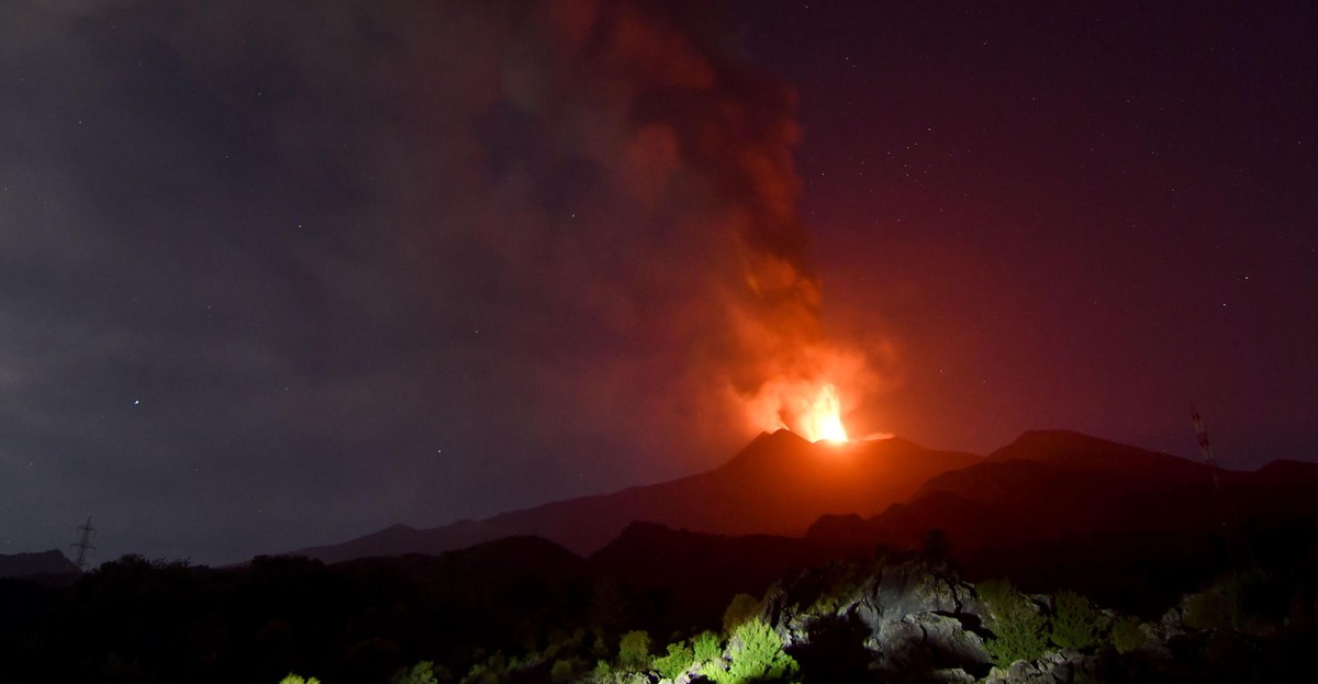 epa11480944 The Mount Etna volcano spews lava during an eruption in Sicily island, Italy, 15 July 2024 (issued 16 July 2024). Mount Etna's Voragine crater spewed lava through the night, with a co ...